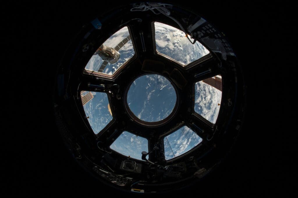 view of earth , through windows from inside capsule